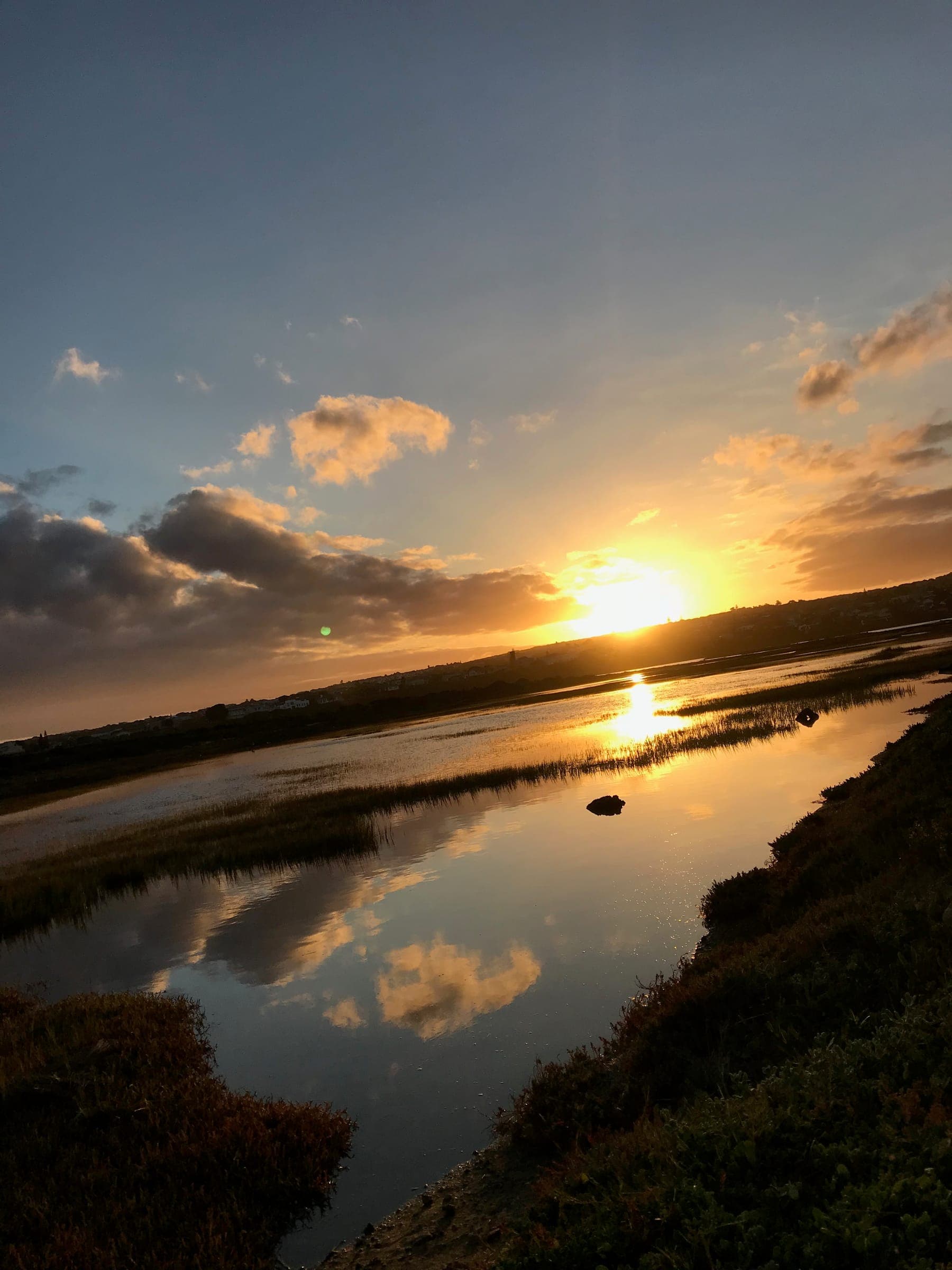 A gold sunset reflected in a channel of the Goukou estuary near Stilbaai.