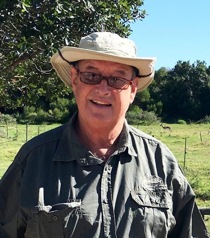 Gavin Bryant in a sun hat and glasses on the farm.