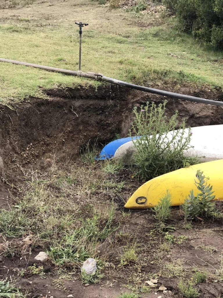 The farm’s two kayaks pulled up on the riverbank, ready to launch from the jetty.