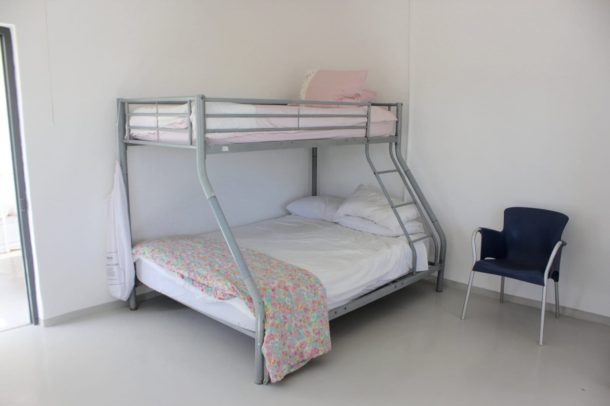 The children’s room at White House Cottage with a double bunk bed and a reading chair.