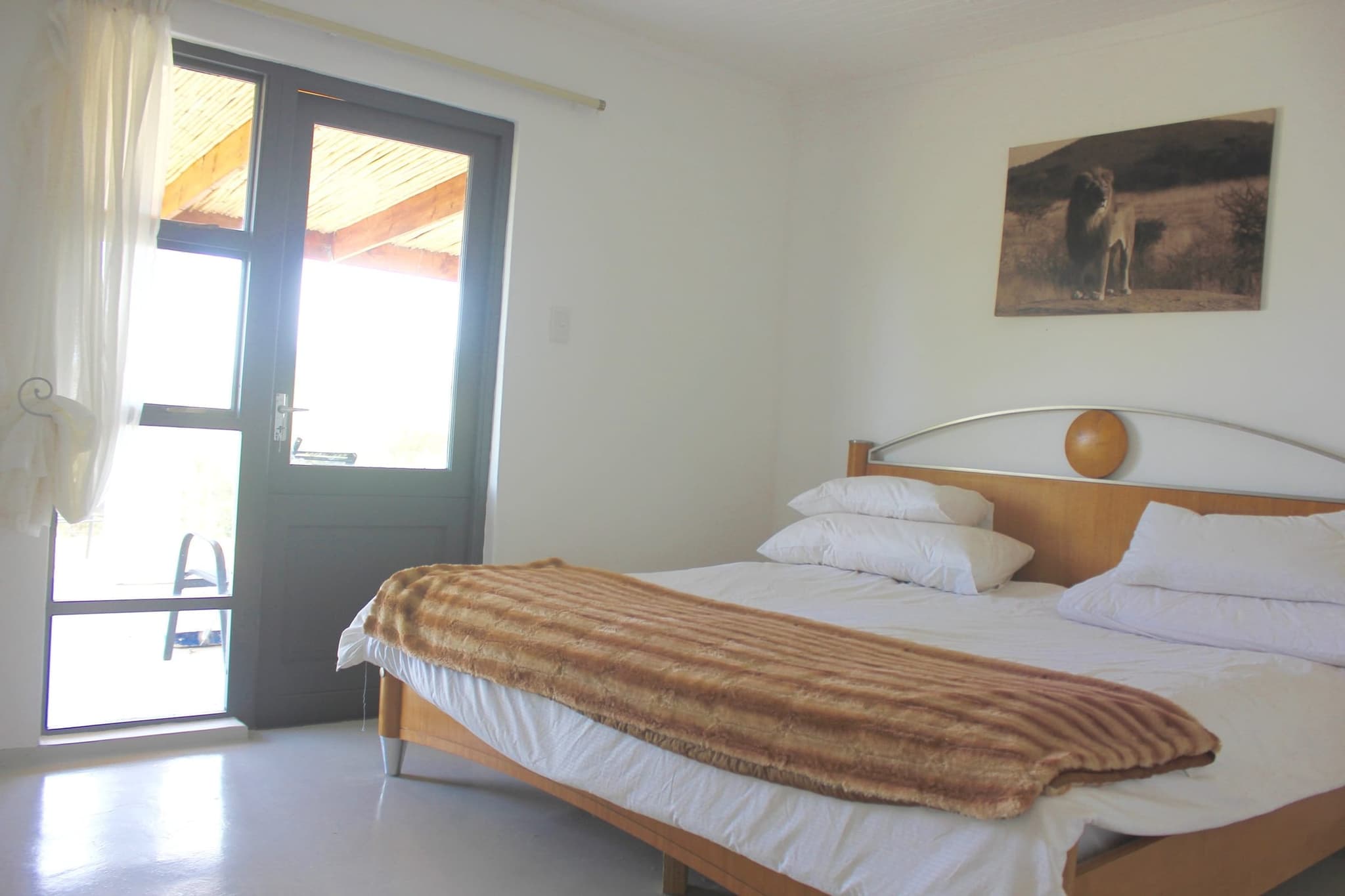 Master bedroom 1 at White House Cottage: a king-size bed and a glass door straight onto the veranda.