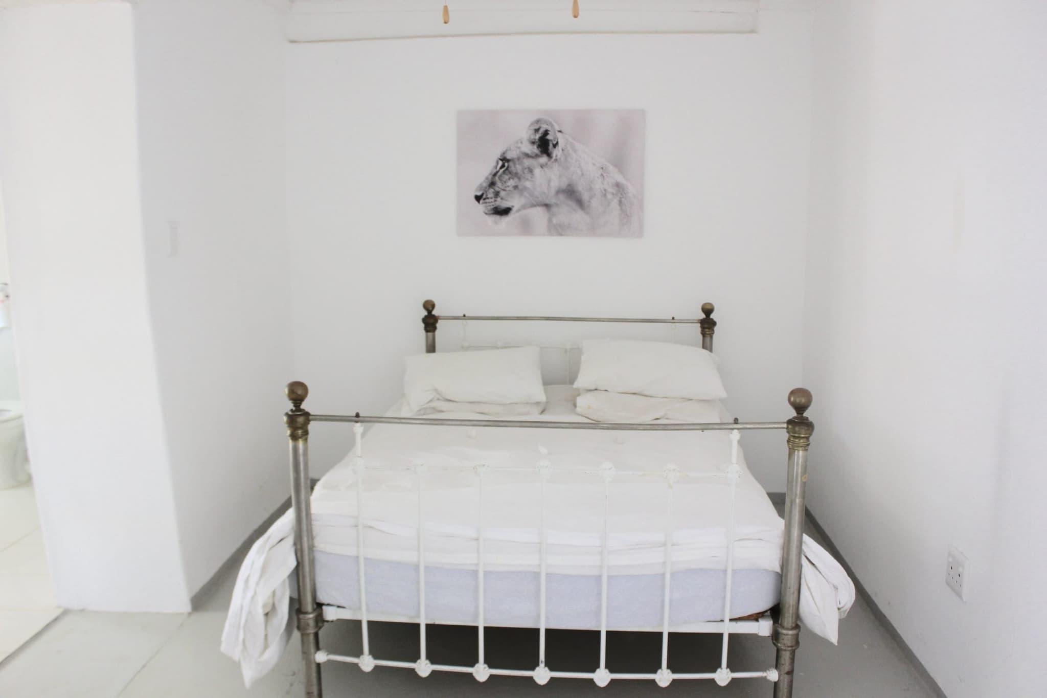 Master bedroom 2 at White House Cottage, with its own en-suite and an old Victorian brass bed.