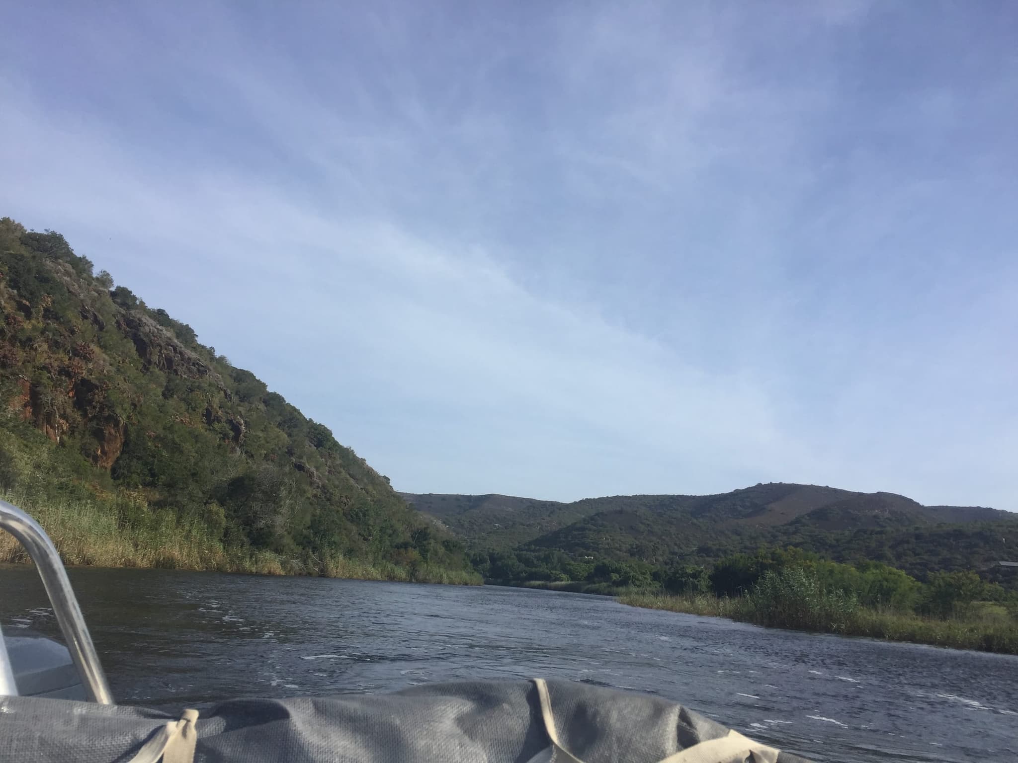 Heading upriver by boat into the wooded gorge of the Goukou.