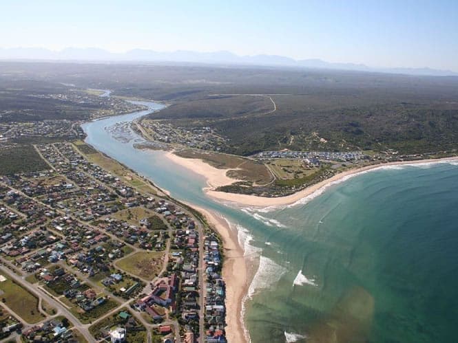 Aerial view of Stilbaai and the mouth of the Goukou River meeting the Indian Ocean.