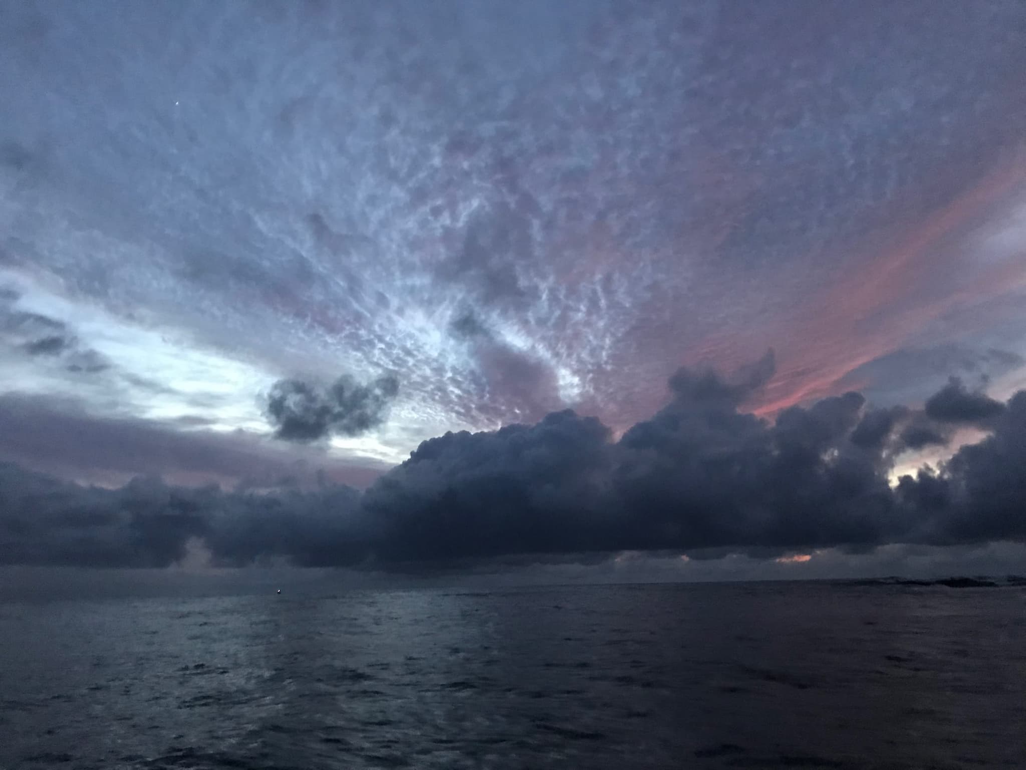 Storm clouds and a pink evening sky over the sea off Stilbaai.